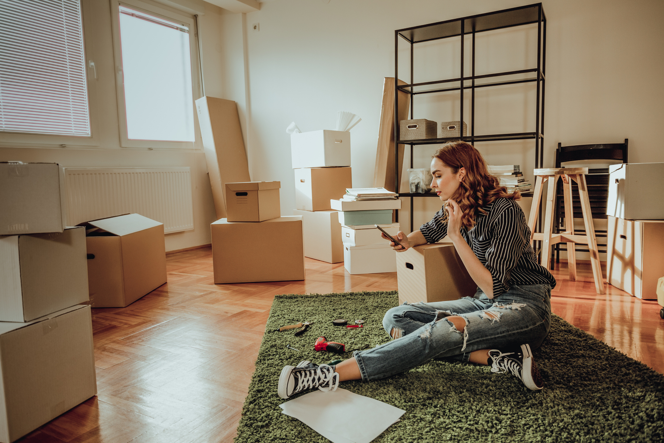 Generation Z woman sitting in the living room of her new home.