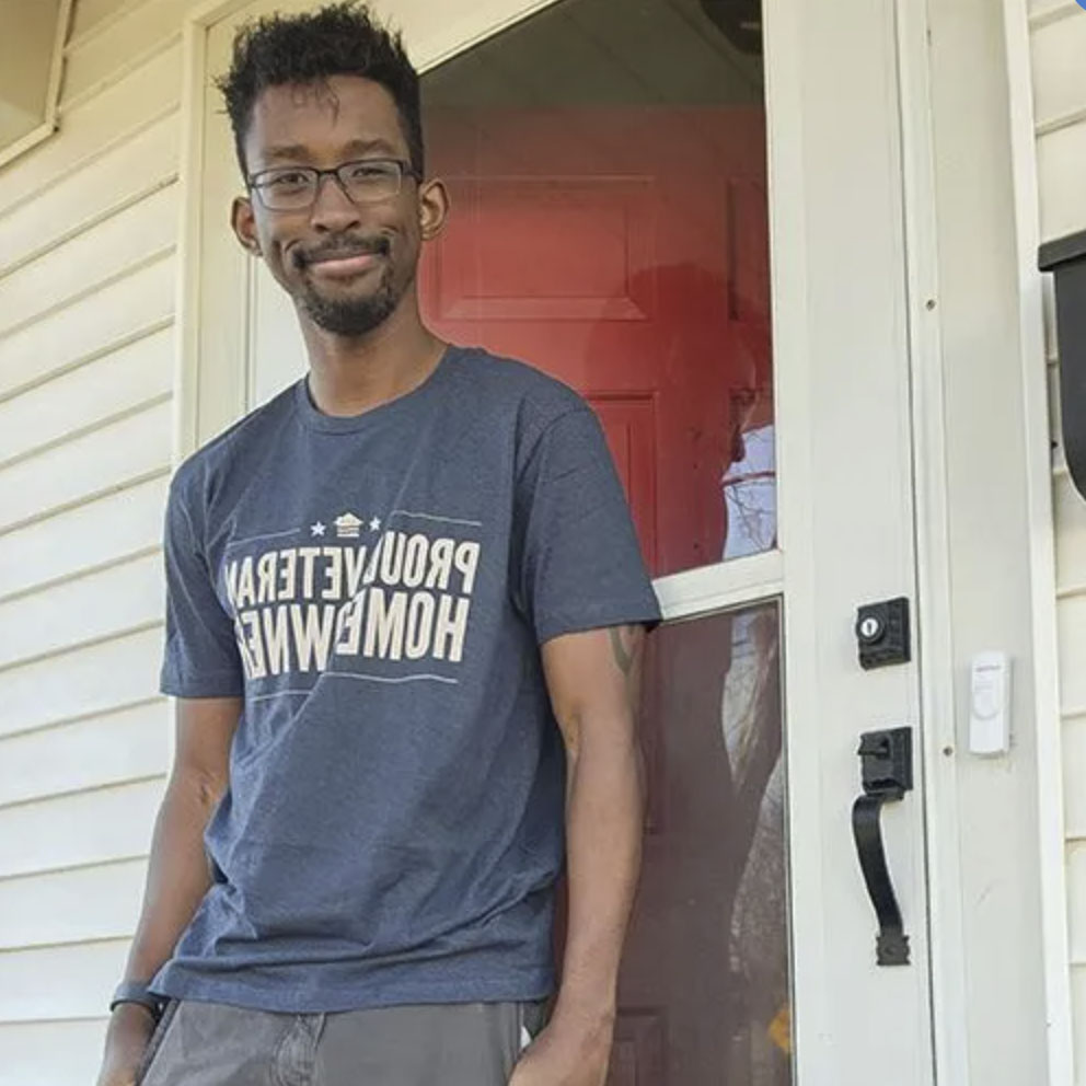 picture of Myles H. in front of a house