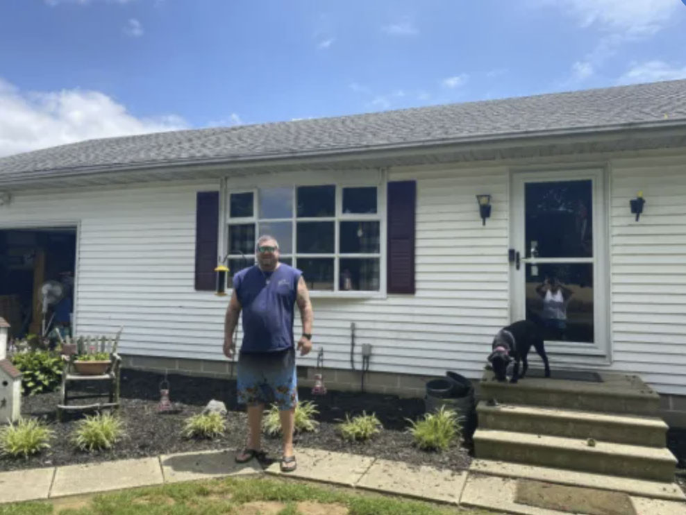 picture of David K. in front of a house